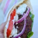 Close up of an gyro burger in a pita.