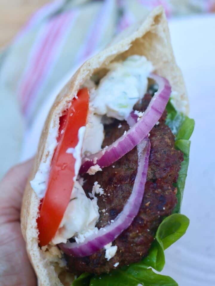 Close up of an gyro burger in a pita.